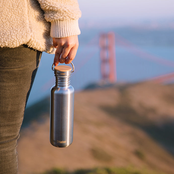 27oz-reflect-with-bamboo-cap-z0 K27SSLRF-BS-BAMBOO_reflect_bottle_bridge_lifestyle.jpg